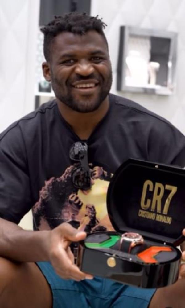 Francis Ngannou poses for a picture with Cristiano Ronaldo