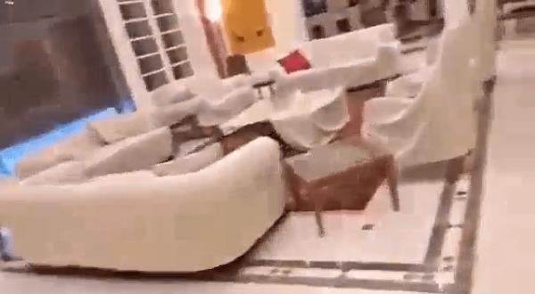 People remove the Syrian flag from the entrance of ousted president Bashar al-Assad's Al-Muhajirin residence in Damascus on December 8, 2024. 