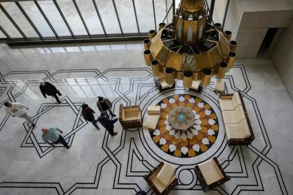 People walks through the halls of Syrian President Bashar Assad's presidential palace.