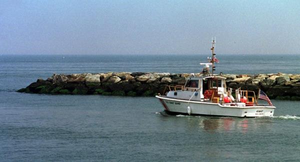 US Coast Guard boat heading out from Mattituck Inlet on Long Island Sound to join the search for missing airplane carrying John F. Kennedy Jr. and his wife Carolyn Bessette Kennedy, 1999