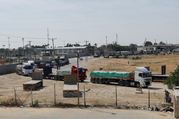 Trucks carrying aid wait to exit, on the Palestinian side of the border with Egypt, as the co<em></em>nflict between Israel and Palestinian Islamist group Hamas continues, in Rafah in the southern Gaza Strip, October 21, 2023. 