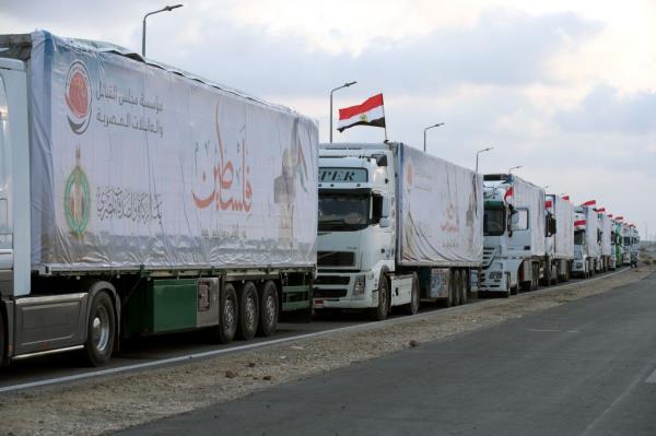 Trucks carrying humanitarian aid bound for the Gaza Strip wait to pass through the Rafah border crossing, Egypt, 24 October 2023. 