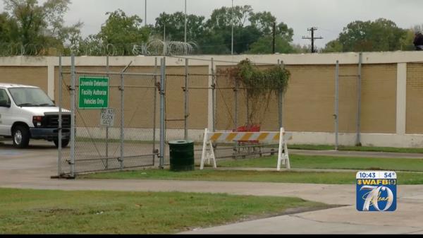 The East Baton Rouge Juvenile Detention Center entrance, featuring a gate covered in barbed wire.