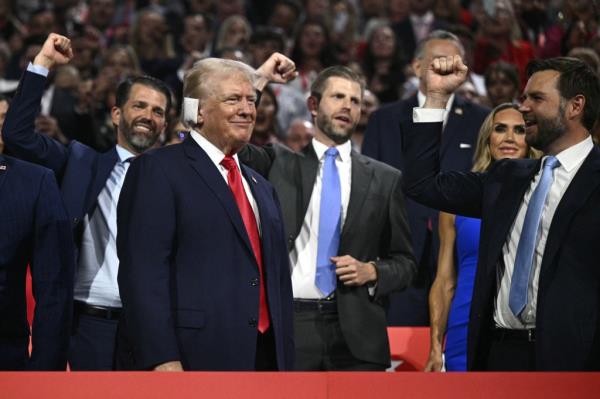 Do<em></em>nald Trump (bottom L) smiles as he is cheered on by US Senator from Ohio and 2024 Republican vice-president candidate J. D. Vance (R) and his sons Do<em></em>nald Trump Jr. and Eric Trump.