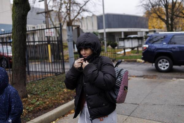 Esperanza closes her jacket to ward off the cold as she travels with her children from their home in Englewood to Stroger Hospital.