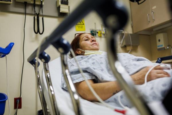 Esperanza waits to get a CT scan at Stroger Hospital. After 14 hours from the time she and her children left their house that morning, doctors rolled her hospital bed out of the room so she could get a scan.