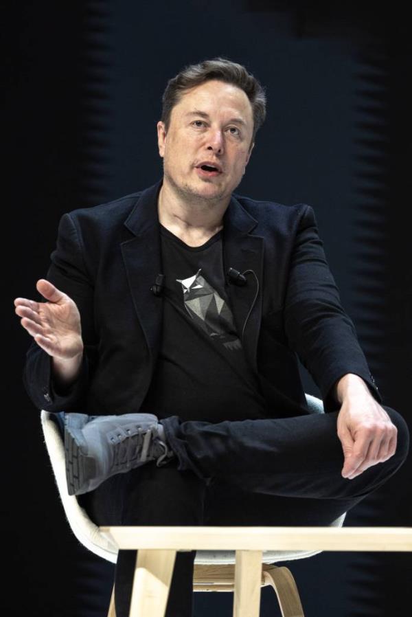 Elon Musk sitting with his legs crossed while attending a co<em></em>nference at the 71st Cannes LIONS Internatio<em></em>nal Festival of Creativity, 2024