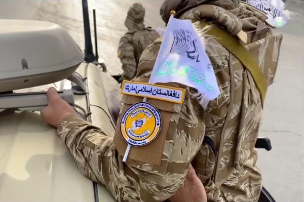 The Taliban fighters' uniforms featured flags of the Islamic Emirate of Afghanistan.