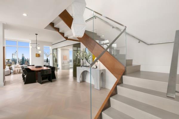 A modern staircase anchors the duplex