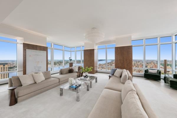 A large living room with large windows in one of the four bedrooms of the GIMME 200 Amsterdam penthouse