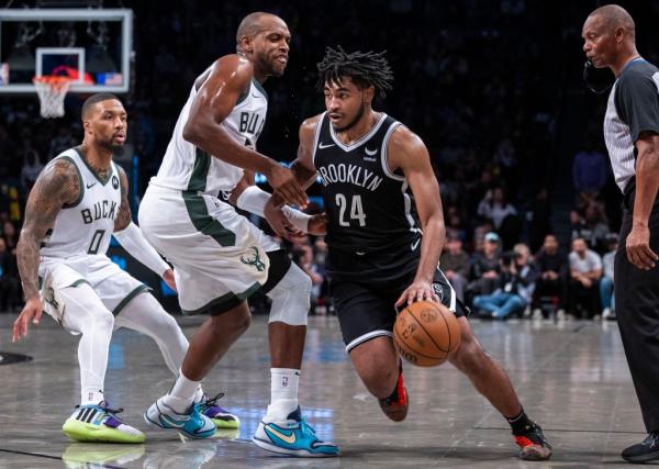 Cam Thomas, driving past Khris Middleton, scored 45 points in the Nets' loss to the Bucks.