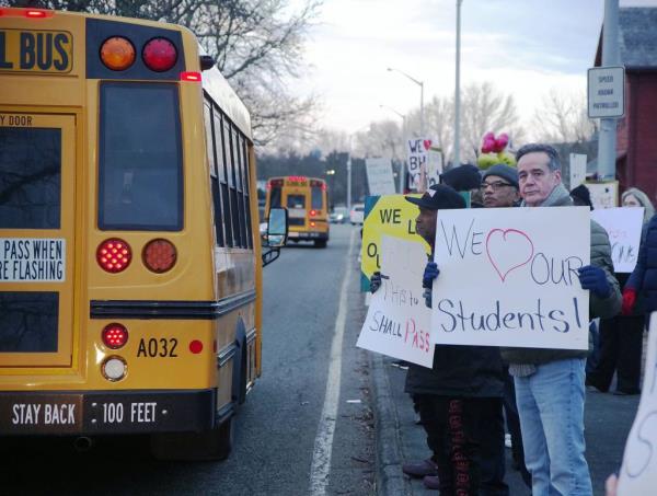 Marc Osborne of Brockton (R) holds an affectio<em></em>nate sigh for Brockton High School students as they enter the high school for classes on Mo<em></em>nday morning on Monday, Feb. 26, 2024.