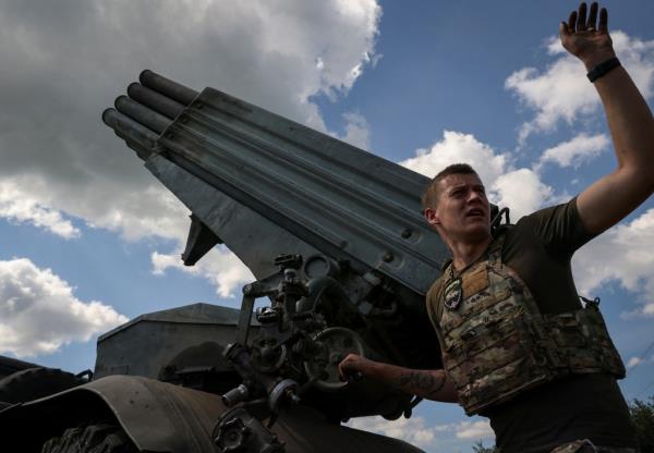 A Ukrainian serviceman of the 59th Separate Motorised Infantry Brigade of the Armed Forces of Ukraine prepares to fire a BM-21 Grad multiple launch rocket system towards Russian troops near a front line, amid Russia's attack on Ukraine, near the town of Avdiivka,
