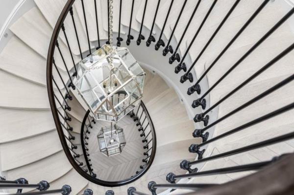 A dramatic spiral staircase co<em></em>nnects all three floors of the condo.