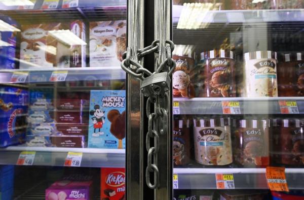 Doors to ice cream display locked up with a padlock and chain