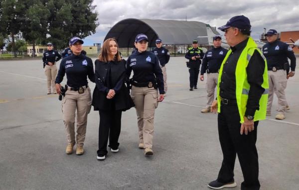 Nancy Go<em></em>nzalez (center) being escorted to a private flight from Colombia to Florida on Wednesday.