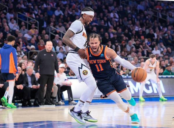 Jalen Brunson is bumped by Kentavious Caldwell-Pope as he drives to the basket during a game against the Nuggets earlier this season.