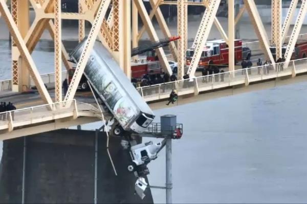 A driver was rescued from a semi-truck dangling over the Ohio River after an accident on a Louisville, Kentucky bridge.