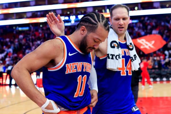 Jalen Brunson #11 of the New York Knicks and Bojan Bogdanovic walk off the court after losing to the Houston Rockets 105-103