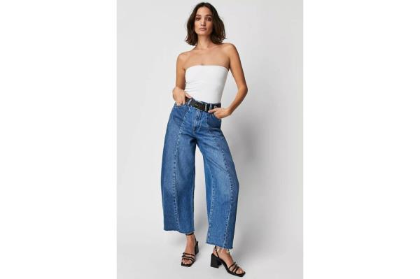 A woman in jeans and white tank