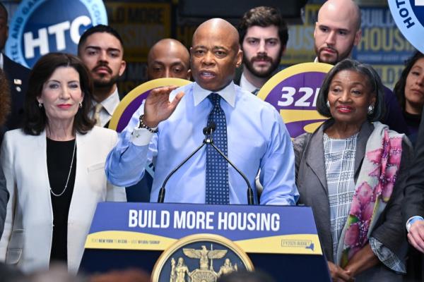 NYC Mayor Eric Adams delivering remarks at NYS Governor Hochul's housing announcement event, alo<em></em>ngside notable figures like Kathy Hochul and Andrea Stewart-Cousins.