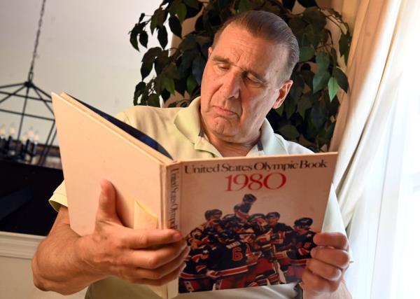 A photo of Giordano reading the 1980 United States Olympic book.