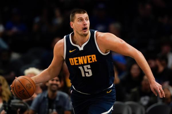 Nuggets center Nikola Jokic looks to pass during the first half of an NBA basketball game