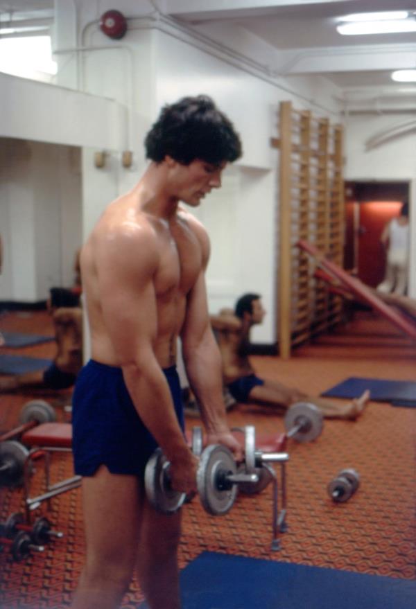 Christopher Reeve lifting a weight. 