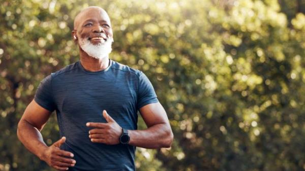 A senior man running in the woods