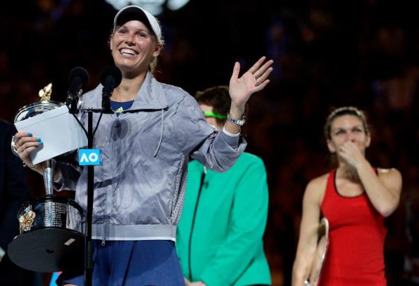 Denmark's Caroline Wozniacki, left, gestures as she addresses the crowd after defeating Romania's Simona Halep, right, in the women's singles final at the Australian Open tennis champio<em></em>nships in Melbourne, Australia, Saturday, Jan. 27, 2018.
