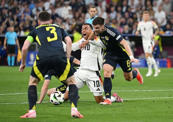 Germany's Jamal Musiala reacts after being fouled by Scotland's Ryan Christie. 