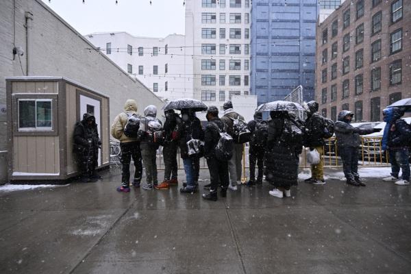NYC Migrants. Friday, January 19, 2024 PICTURED: Migrants seen awaiting to be admitted into a Men's Migrant Super Center on Hall street in Brooklyn. The shelter houses around 2000 migrants.