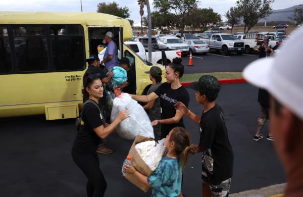 Volunteers with King's Cathedral Maui unload do<em></em>nations of blankets and supplies on August 10, 2023 in Kahului, Hawaii.
