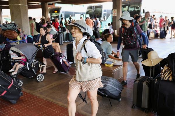 Evacuees from the West Maui wildfires at the Kahului Airport.