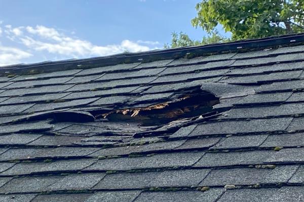 Jeff Ilg shows damage to his home, in Shirley, Mass., wher<em></em>e a chunk of ice landed on the roof late Sunday, Aug. 13, 2023.