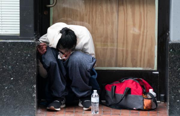 A person smokes fentanyl on Wednesday, April 12, 2023, in downtown Portland, Ore.