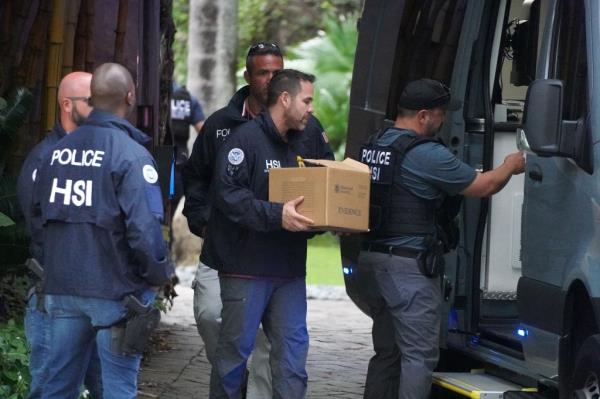 Law enforcement were removing boxes of evidence and a laptop from Diddy's Star Island mansion