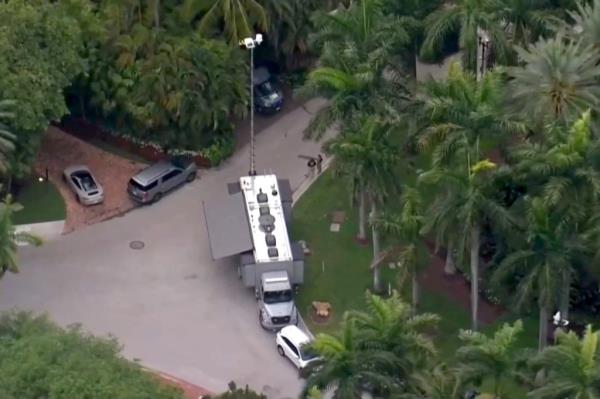U.S. authorities are seen outside the home of Sean 