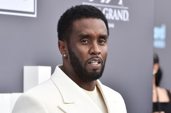 Music mogul Sean 'Diddy' Combs in a white suit arriving at the Billboard Music Awards 2022 in Las Vegas