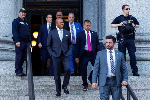 New York City Mayor Eric Adams exiting the US federal courthouse, accompanied by a group of men in suits, on November 01, 2024