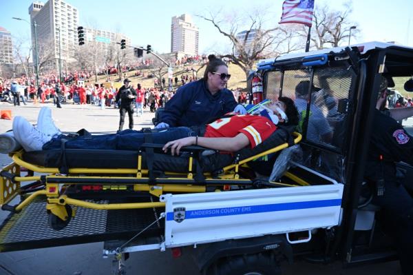 A person lying in a stretcher after shots were fired near the Kansas City Chiefs' Super Bowl LVIII victory parade.