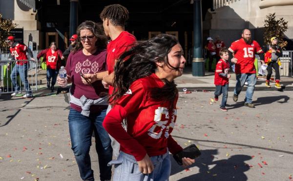 People running away after shots were fired during the Kansas City Chiefs' Super Bowl victory parade, as police investigate the scene.