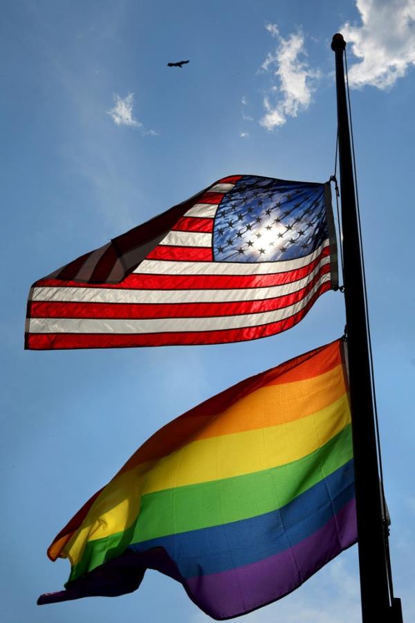 The U.S. and gay pride flags fly at half-mast over the GLBT Community Center of Central Florida in memory of Pulse nightclub massacre victims.