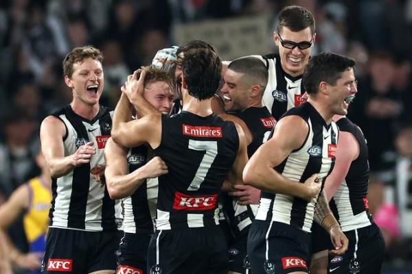 Joe Richards of the Magpies is co<em></em>ngratulated by teammates.