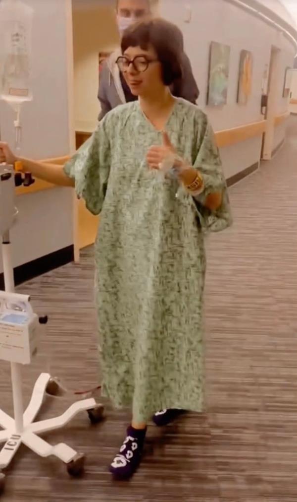 Kate Micucci walking with an IV in a hospital. 