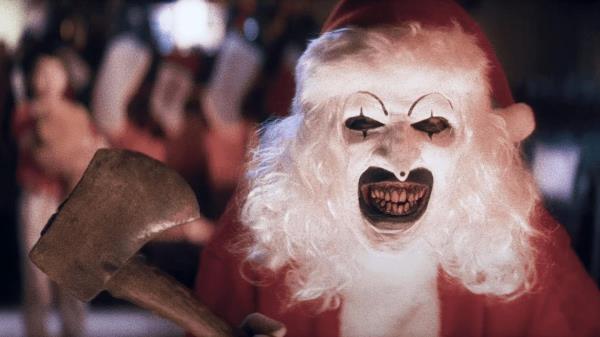 David Howard Thornton as Art the Clown in Terrifier 3 holding an ax
